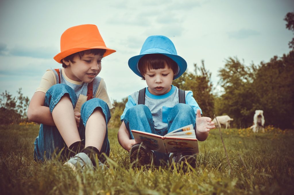young boys in hats reading children's books