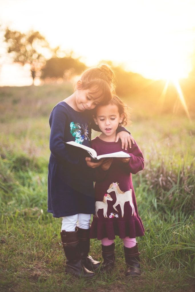 Two girls reading children's books